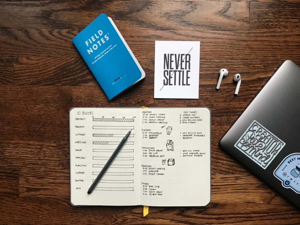 a notebook and pen on a table