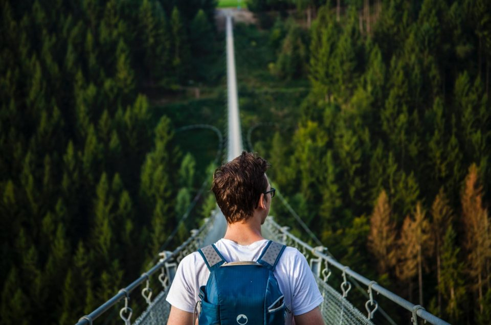 a man standing on a suspension bridge