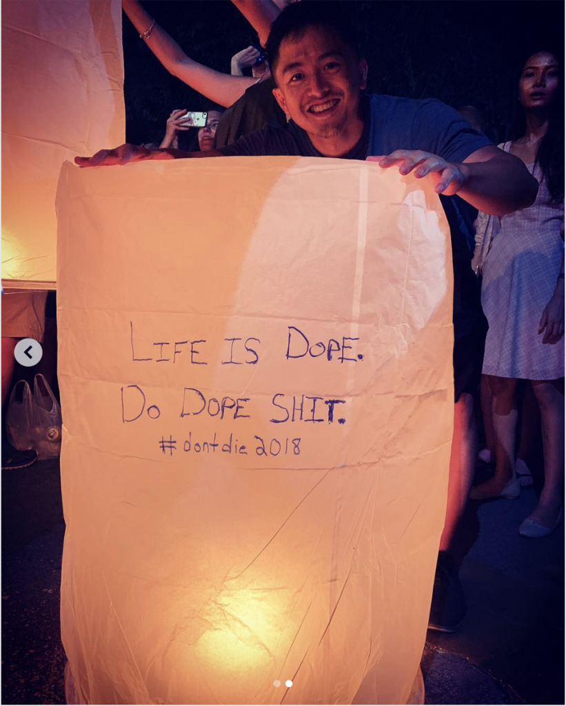 a man holding a paper lantern