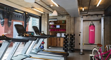 a room with treadmills and a man in the background
