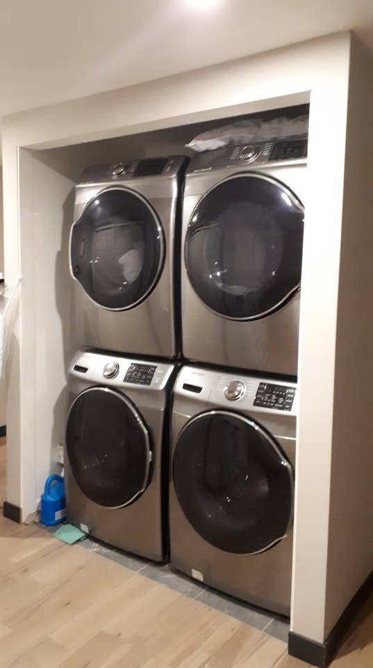 a stack of washing machines in a closet