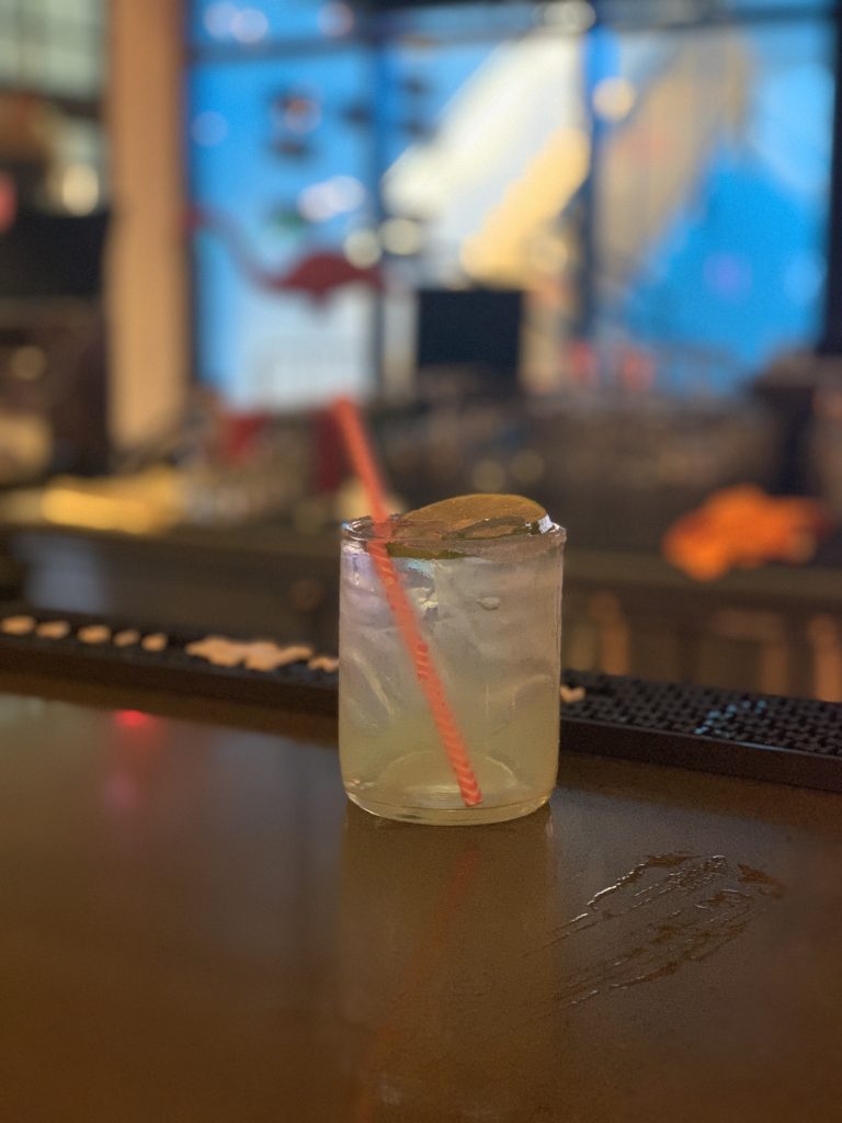 a glass with a straw and a lime in it