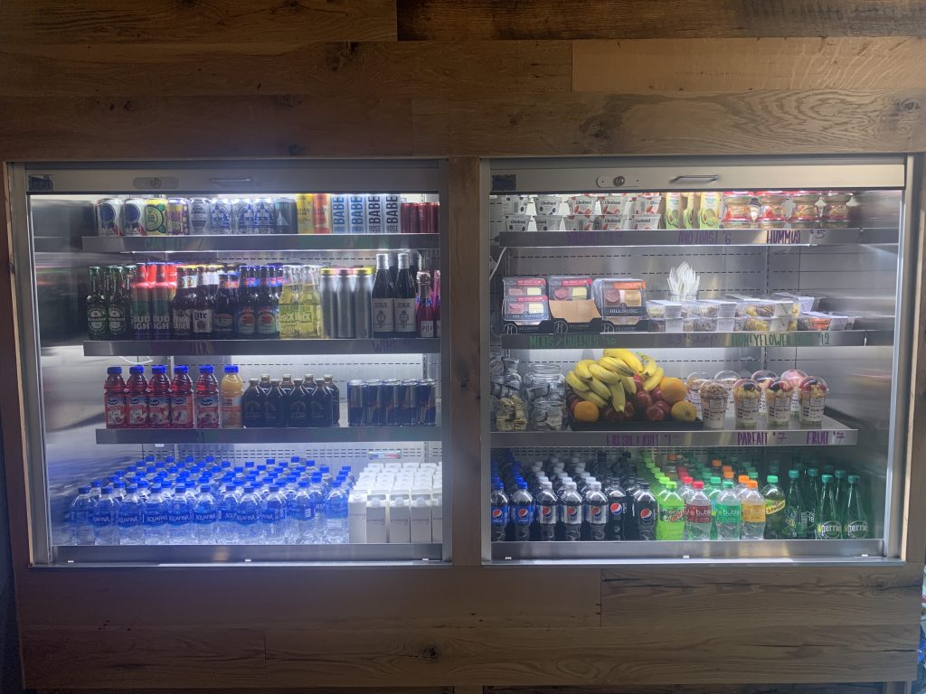 a display case with drinks and beverages