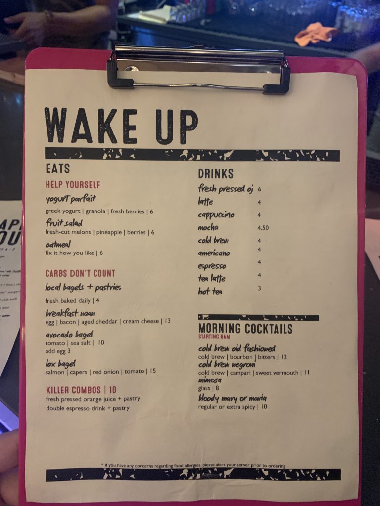 a pink clipboard with a white paper with black text