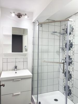 a bathroom with a shower and sink