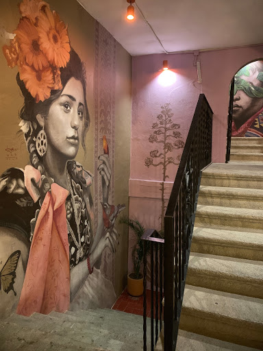 a staircase with a mural on the wall