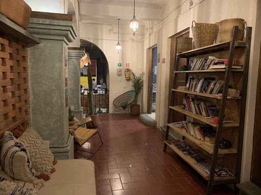 a room with a book shelf and a chair