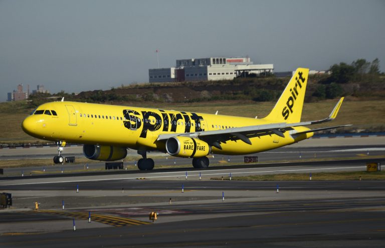 a yellow airplane on a runway