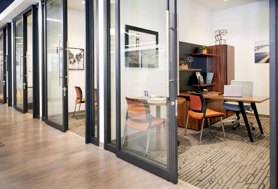 a room with glass doors and a table and chairs