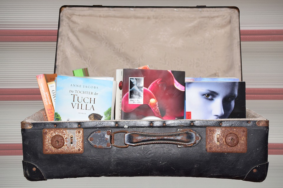a suitcase with books and magazines
