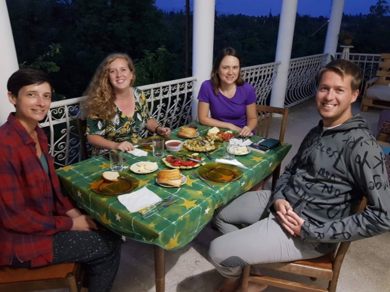 a group of people sitting at a table with food