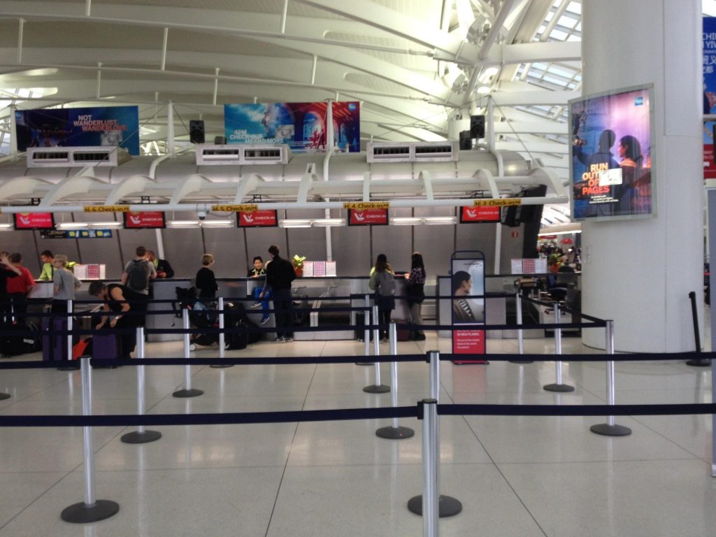 people standing in a line at an airport