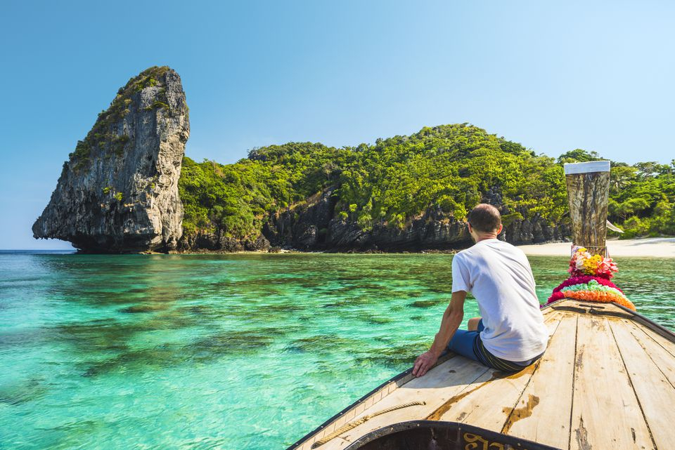 a man sitting on a boat in the water