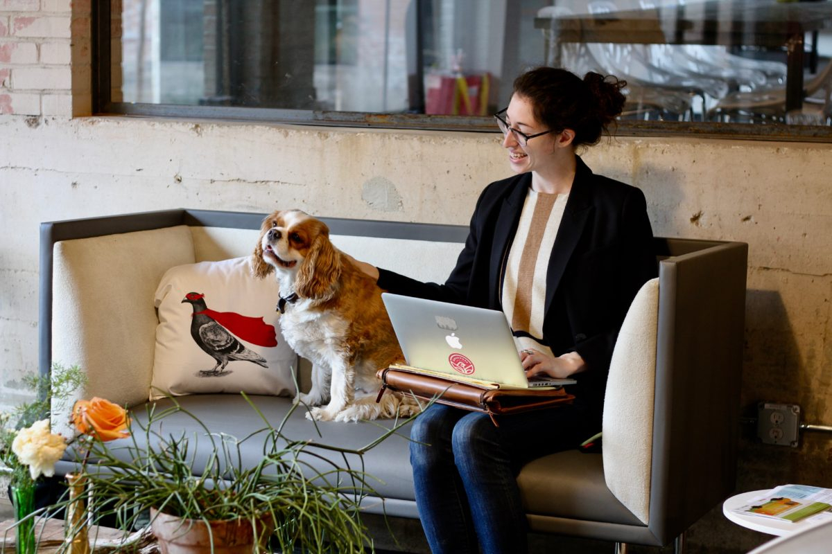 a woman sitting on a couch with a dog on her lap