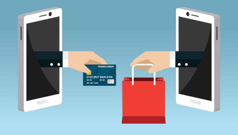 a pair of hands holding a credit card and a shopping bag