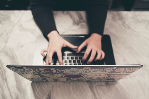 a person typing on a laptop