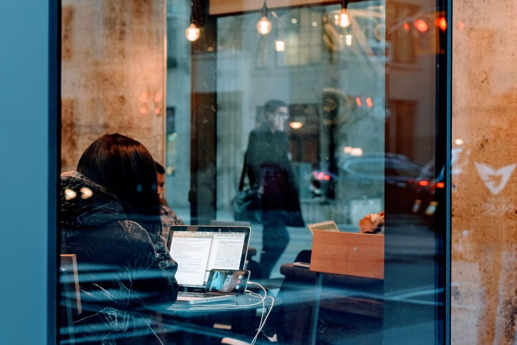 a girl reading about common remote work mistakes on her laptop while working remotely
