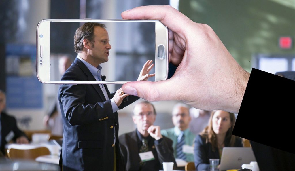 a person recording a business meeting.
