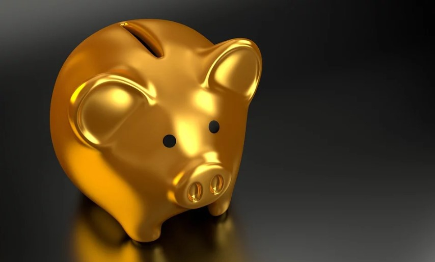 a gold piggy bank on a black background
