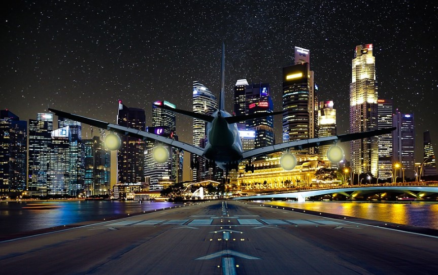 future of travel: plane landing on runway in the city