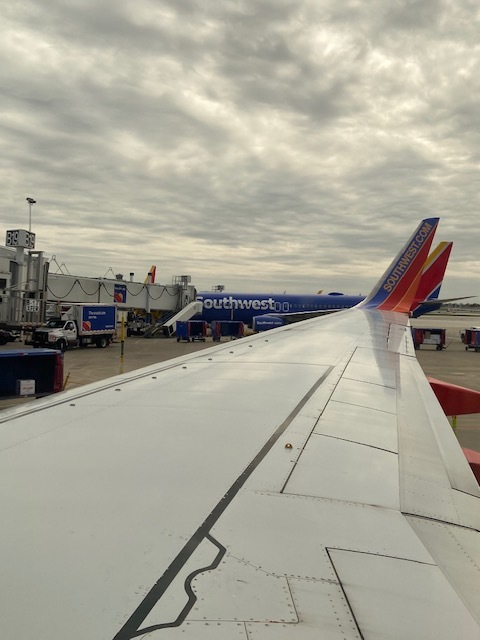an airplane wing with a blue and red tail and a white wing