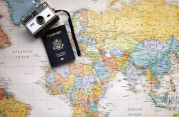 passport and camera on a world map