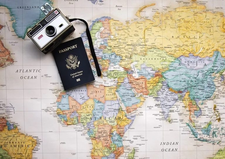 passport and camera on a world map
