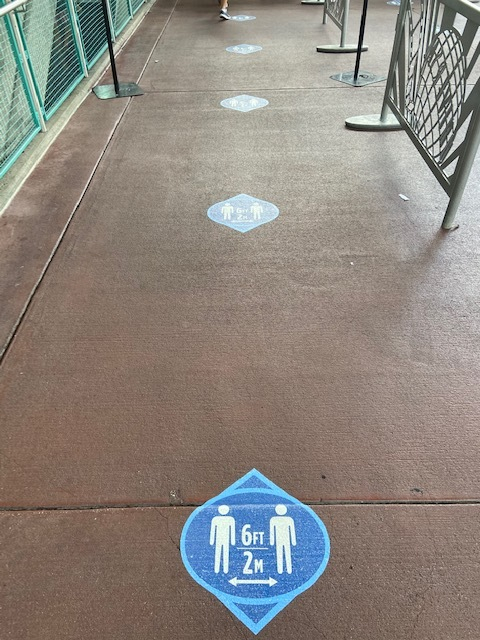 a walkway with blue and white signs on it