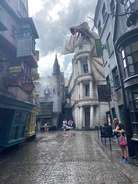 a street with buildings and a dragon on the side
