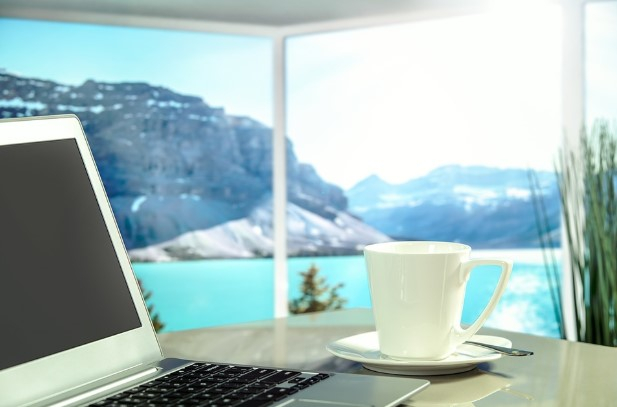 a laptop and a cup of coffee on a table