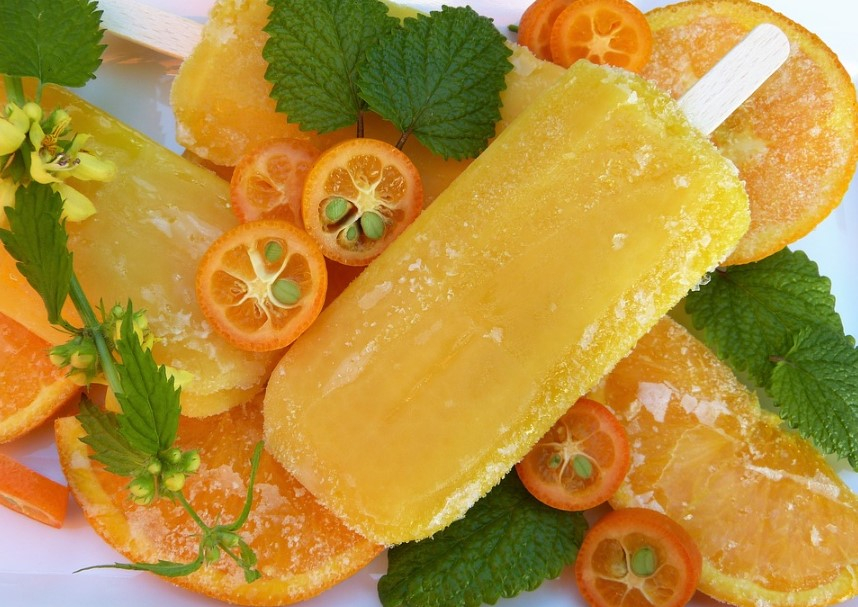 a plate of fruit popsicles