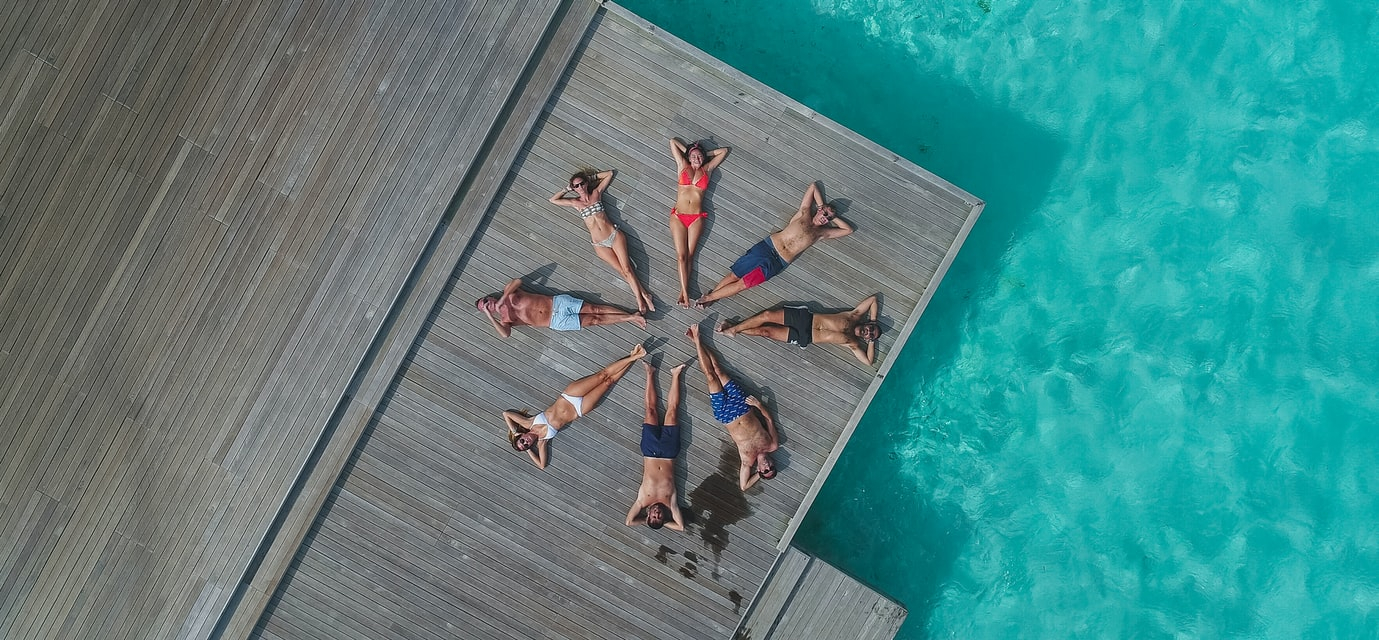 a group of people lying on a dock