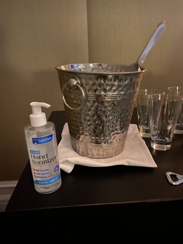 a bucket and a bottle of hand sanitizer