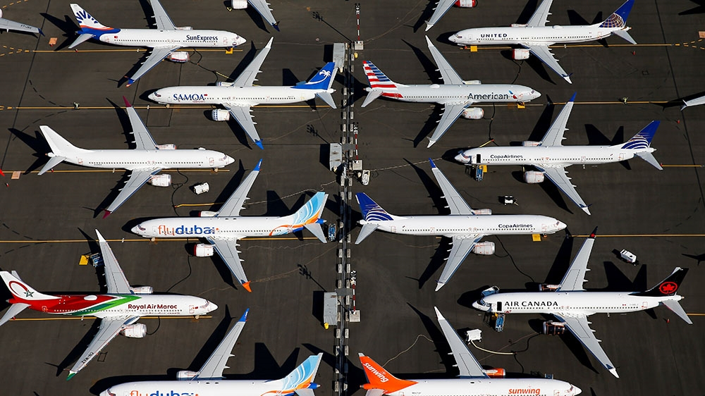 an aerial view of airplanes parked on a runway