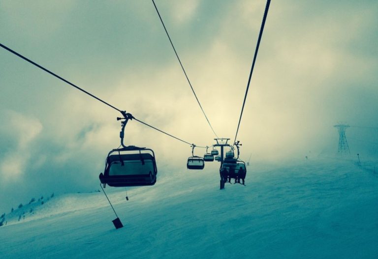 a ski lift with chairs and cables