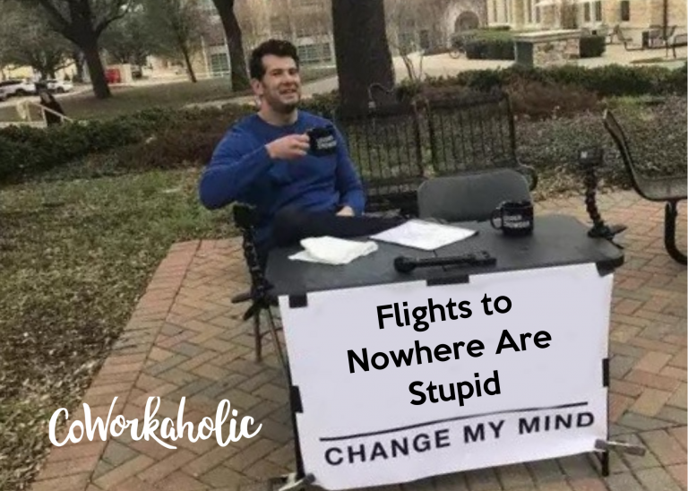 a man sitting at a table with a sign