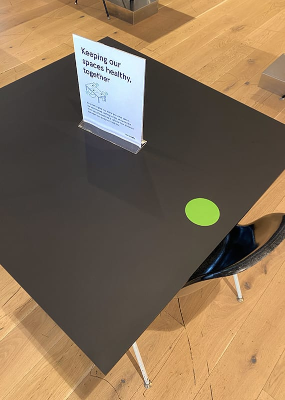 a black square table with a sign on it