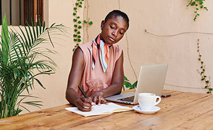 a woman writing on a book