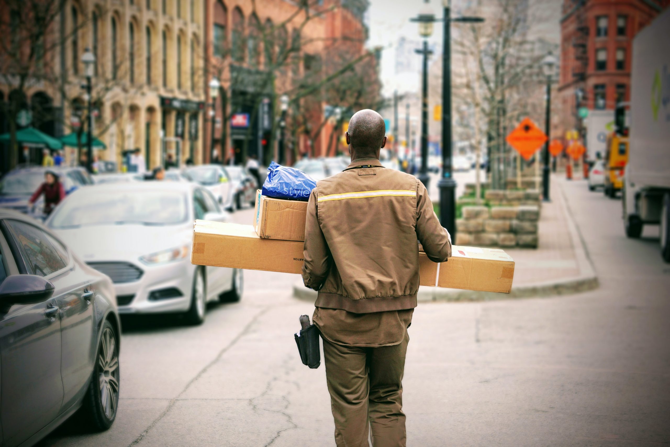 a man carrying boxes on his back