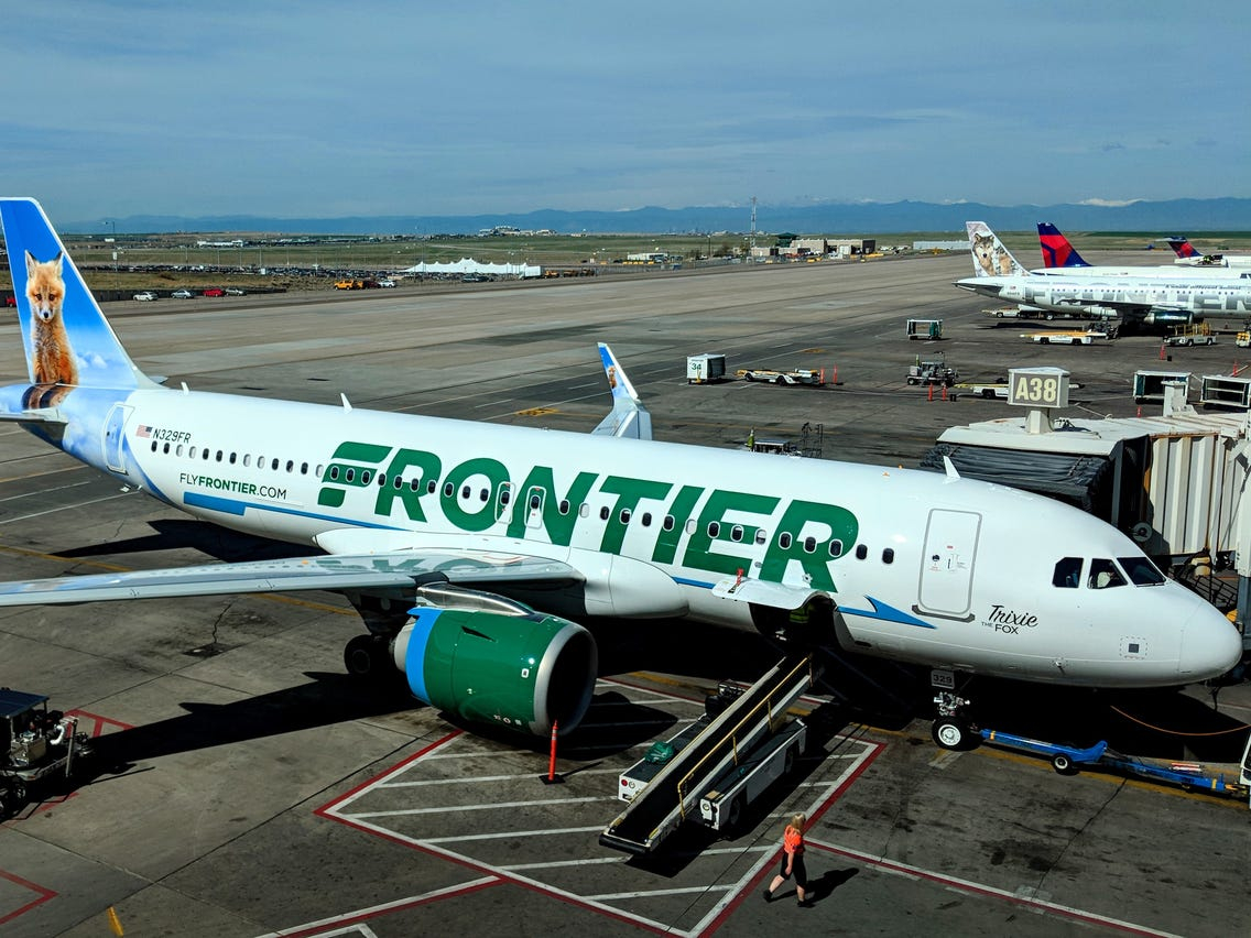 a white airplane with green writing on it