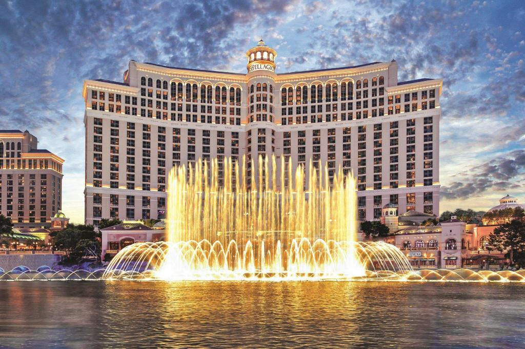 a large building with a fountain in front of it with Bellagio in the background