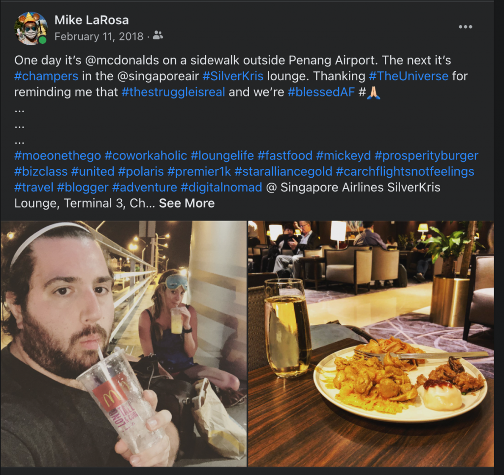 a man holding a drink and a plate of food