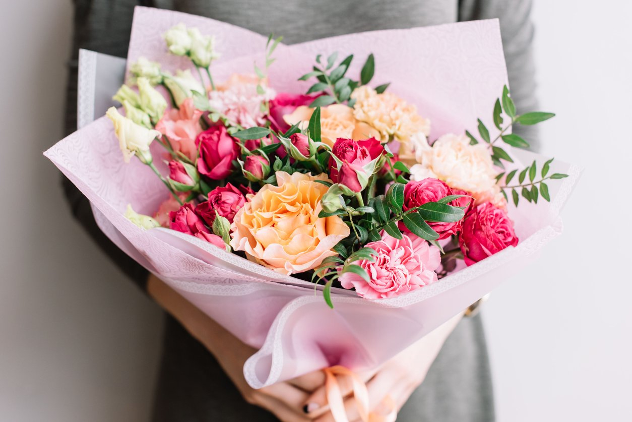 a person holding a bouquet of flowers